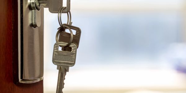 Keys in door lock, close-up view.